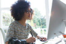 Women working at a desktop